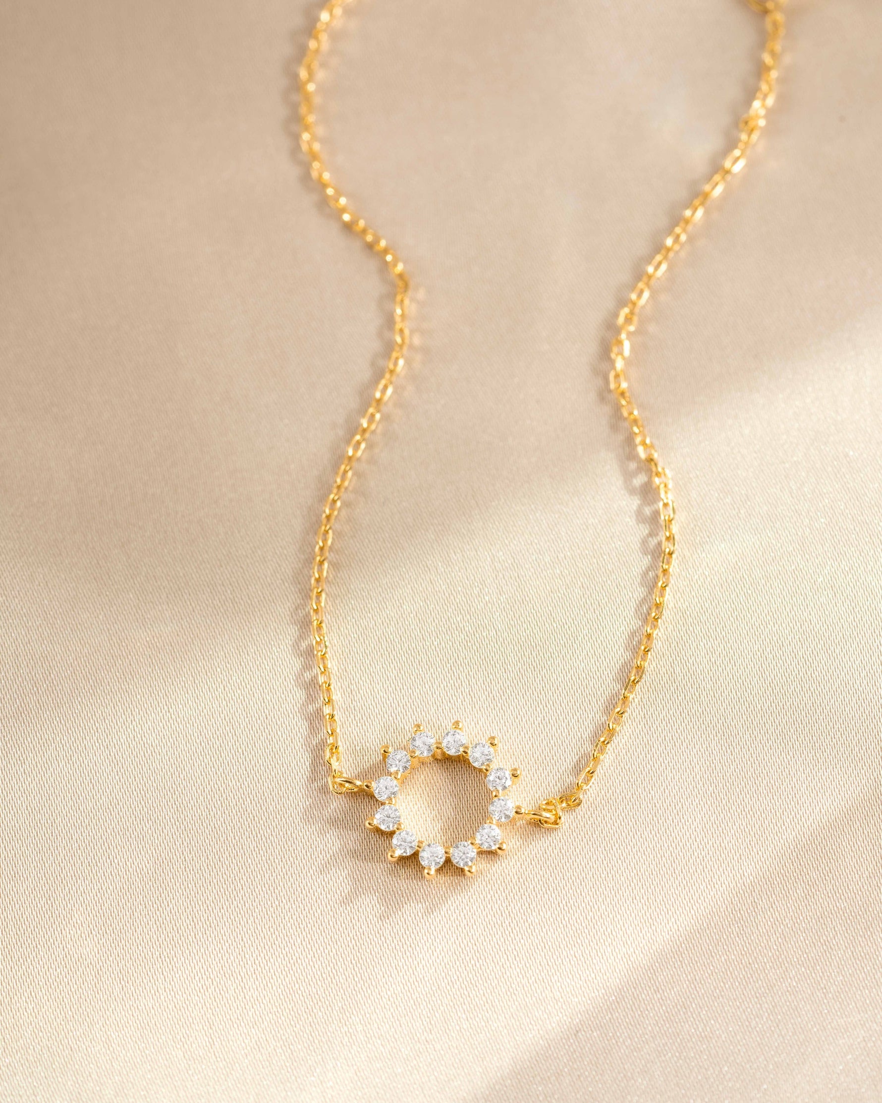 sunburst charm bracelet in gold 