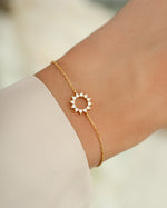 sunburst charm bracelet in gold on model
