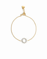 sunburst charm bracelet in gold on a white background 