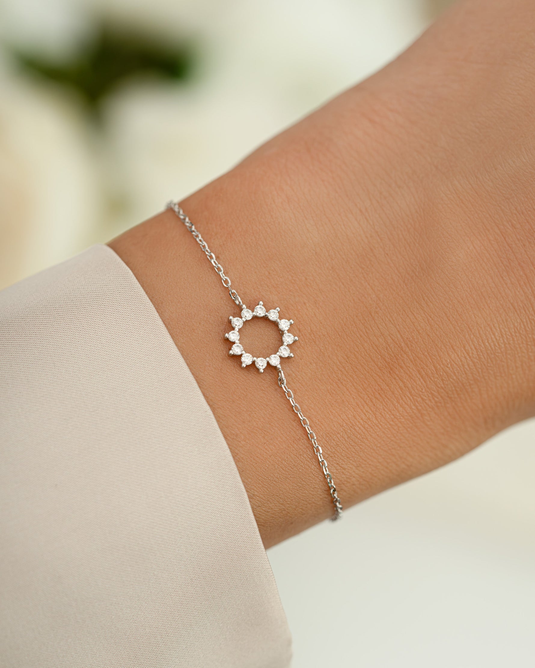 sunburst charm bracelet in sterling silver on models wrist