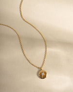 Gold Sunburst Medallion Necklace from Sami Jewels featuring a detailed sunburst design, front view showcasing its elegant pendant.