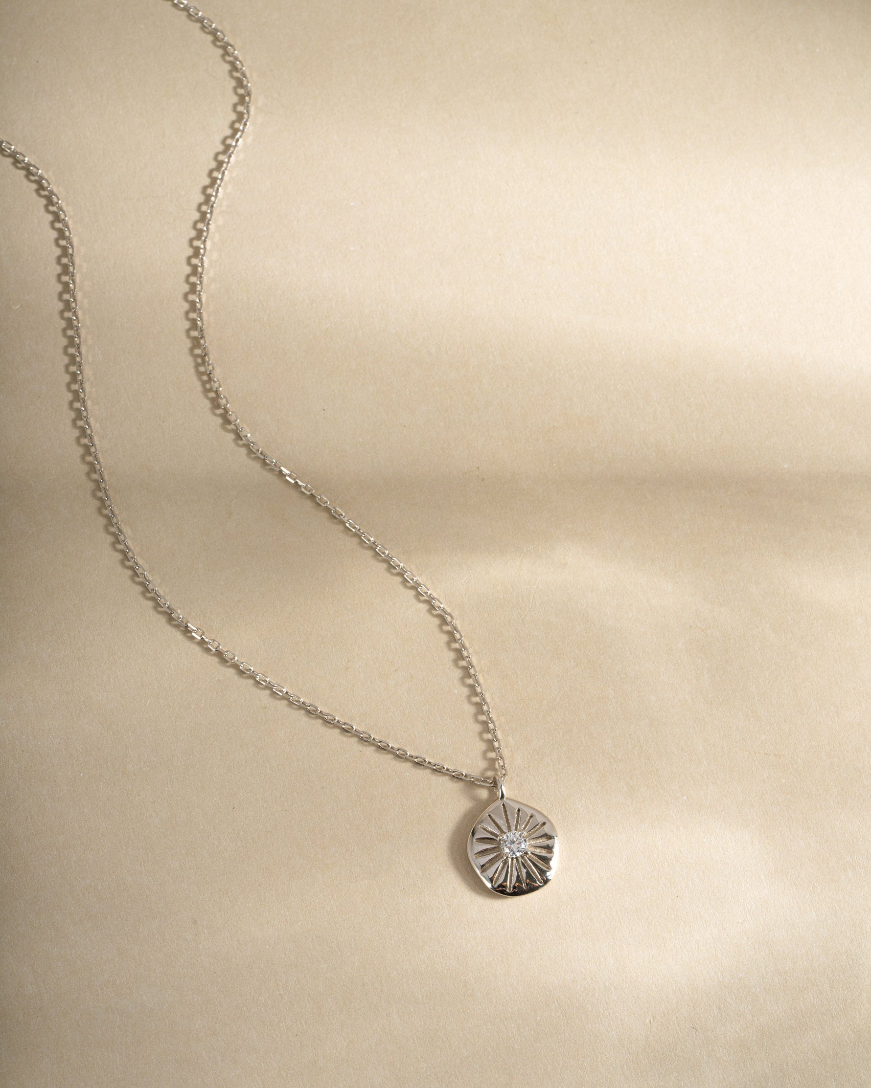 Sterling silver Sunburst Medallion Necklace by Sami Jewels showing front view with intricate sunburst design.