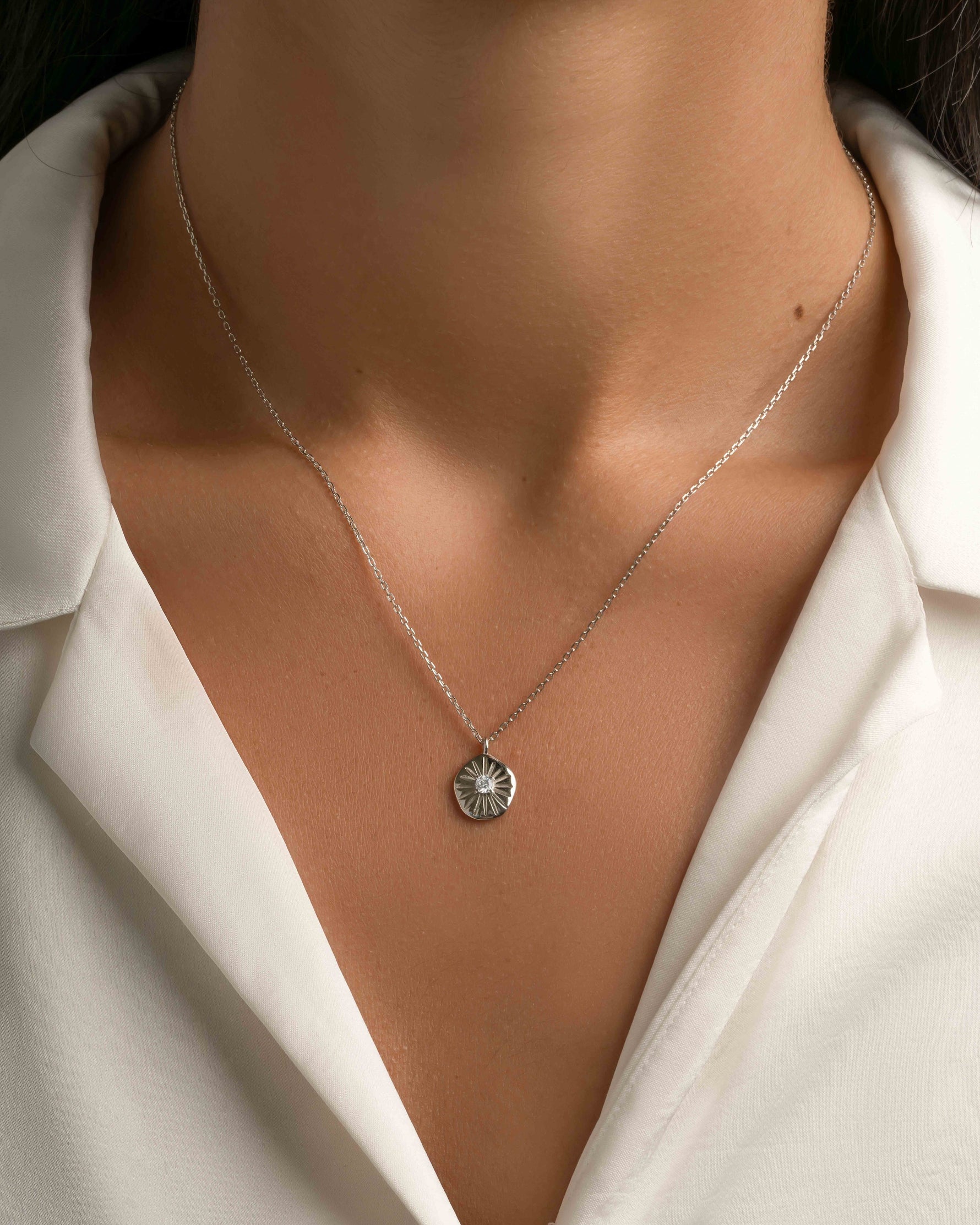 Sterling silver Sunburst Medallion Necklace by Sami Jewels, featuring a detailed sunburst design on a delicate chain.
