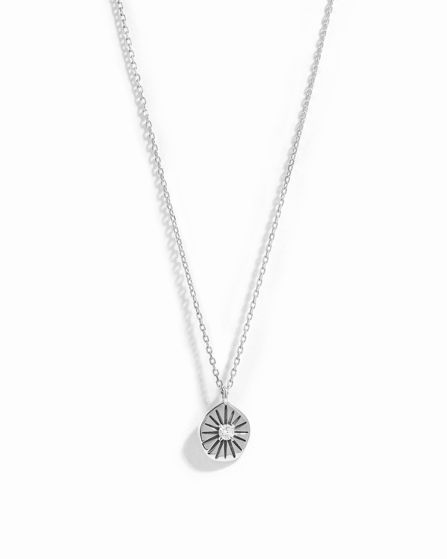 Sterling silver Sunburst Medallion Necklace by Sami Jewels featuring a radiant sunburst design on a white background.