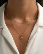 Gold Sunburst Medallion Necklace by Sami Jewels, featuring a detailed sunburst pendant styled on a model.