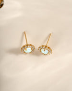 Sami Jewels Sunburst Opal Halo Stud Earrings with radiant opal center and sparkling halo design, top view.