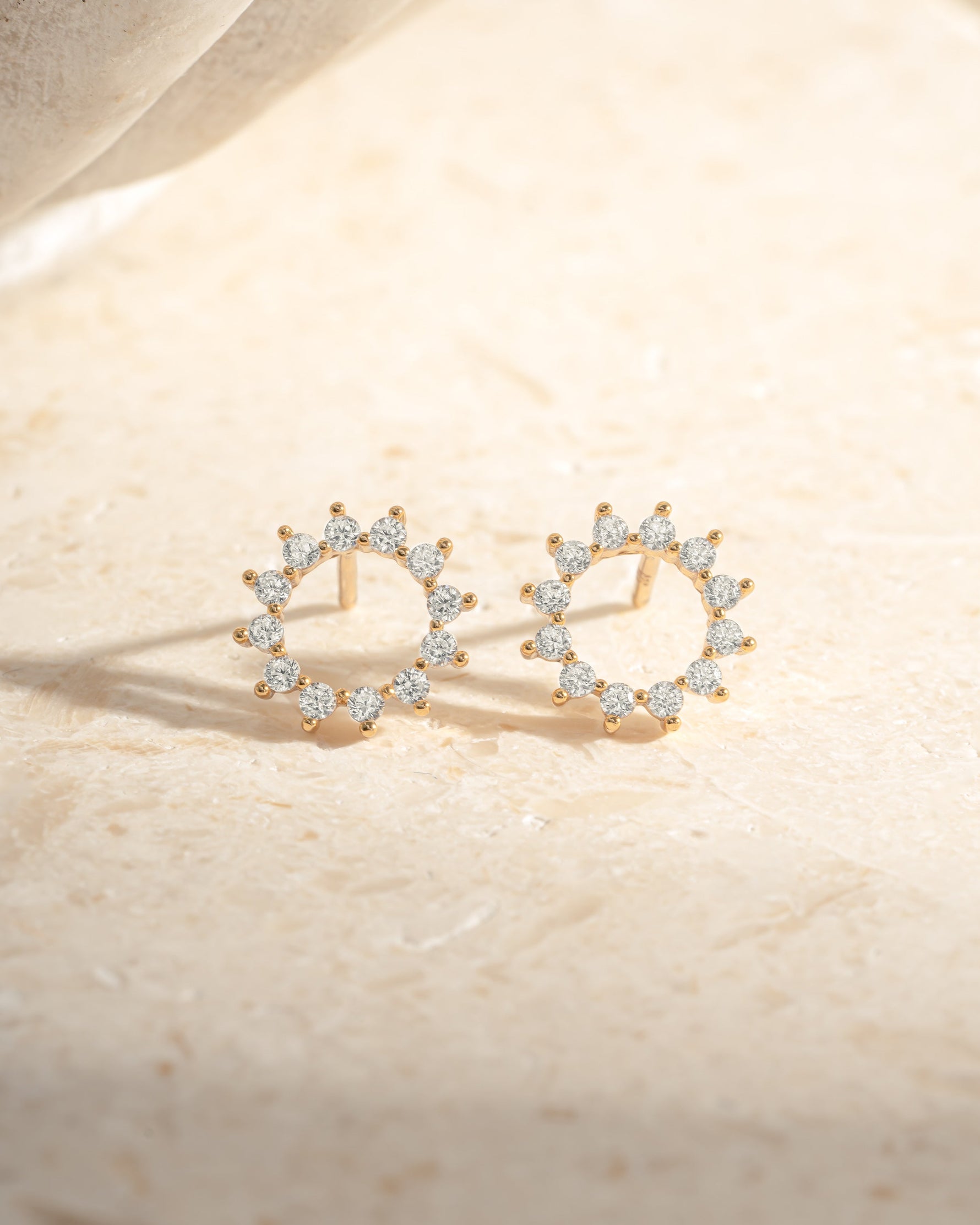 Gold 10mm Sunburst Stud Earrings by Sami Jewels featuring a radiant sunburst design on each earring.