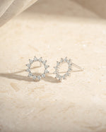 Sterling silver 10mm sunburst stud earrings by Sami Jewels featuring a radiant sunburst design.