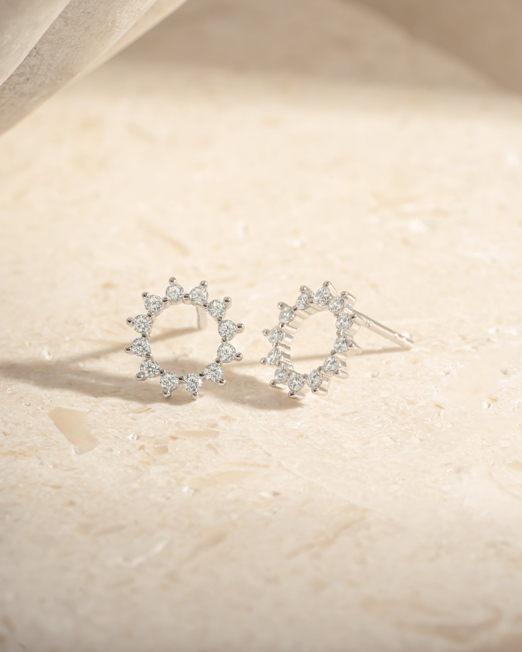 Sterling silver 10mm sunburst stud earrings by Sami Jewels featuring a radiant sunburst design.