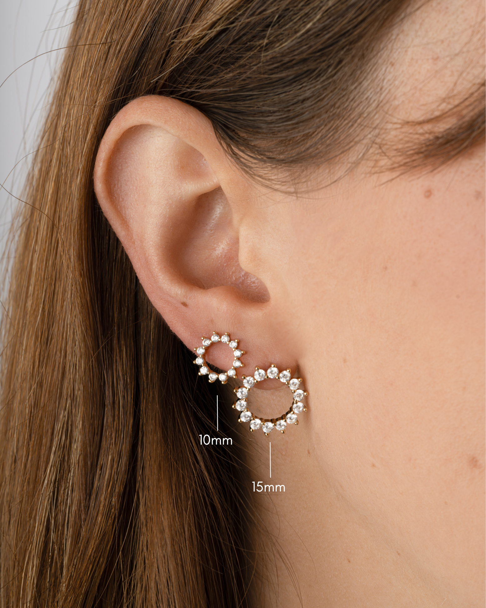 Gold 15mm Sunburst Stud Earrings from Sami Jewels, shown in various sizes on a model.