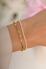 Gold tennis and paperclip bracelet set by Sami Jewels featuring sleek, minimalist designs on a model's wrist.