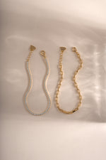 Gold tennis and paperclip bracelet set by Sami Jewels, featuring sleek designs displayed on a neutral background.
