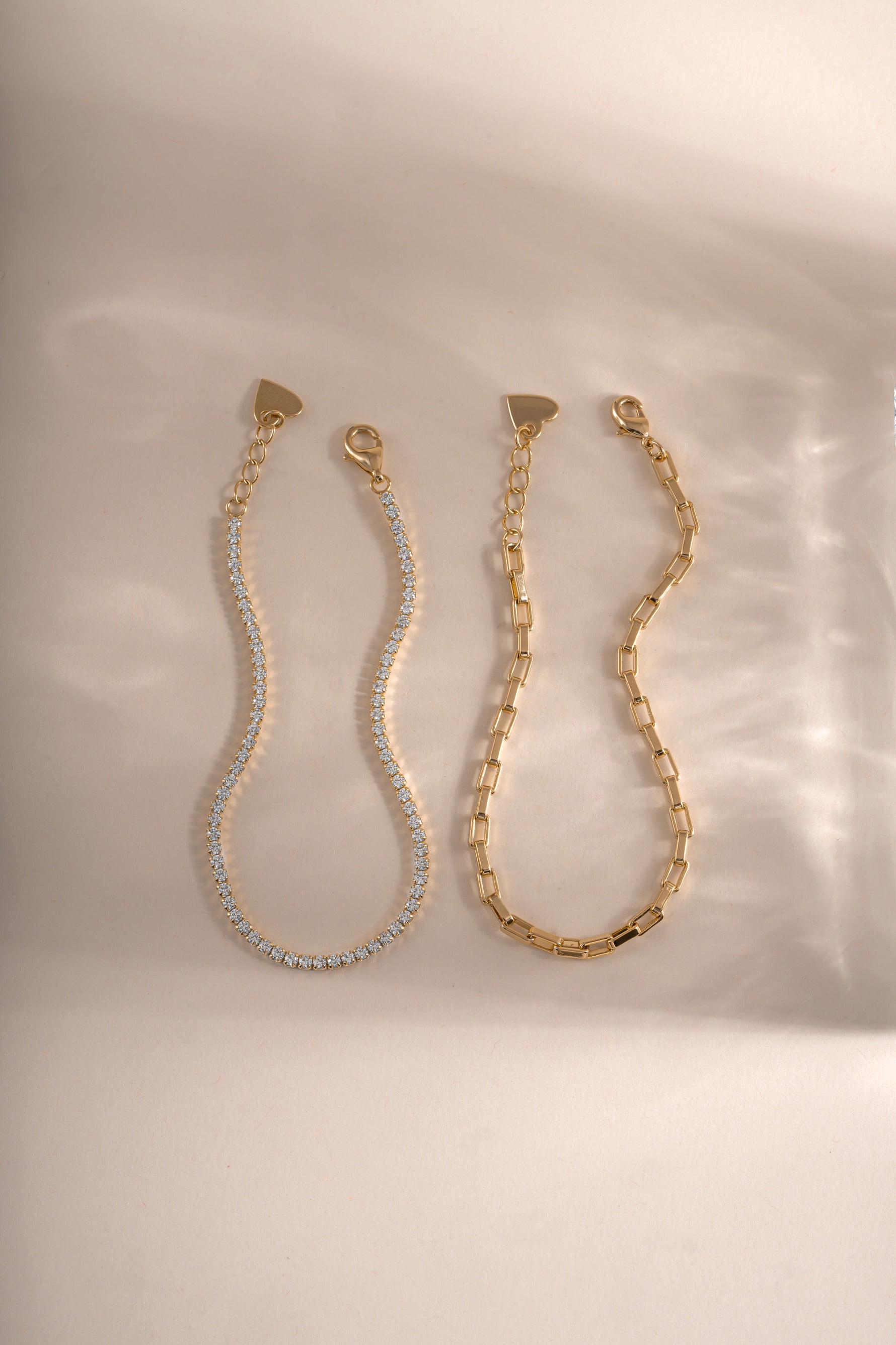 Gold tennis and paperclip bracelet set by Sami Jewels, featuring sleek designs displayed on a neutral background.