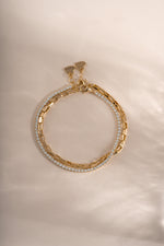 Gold tennis and paperclip bracelet set from Sami Jewels, featuring layered jewelry with sleek, modern design.