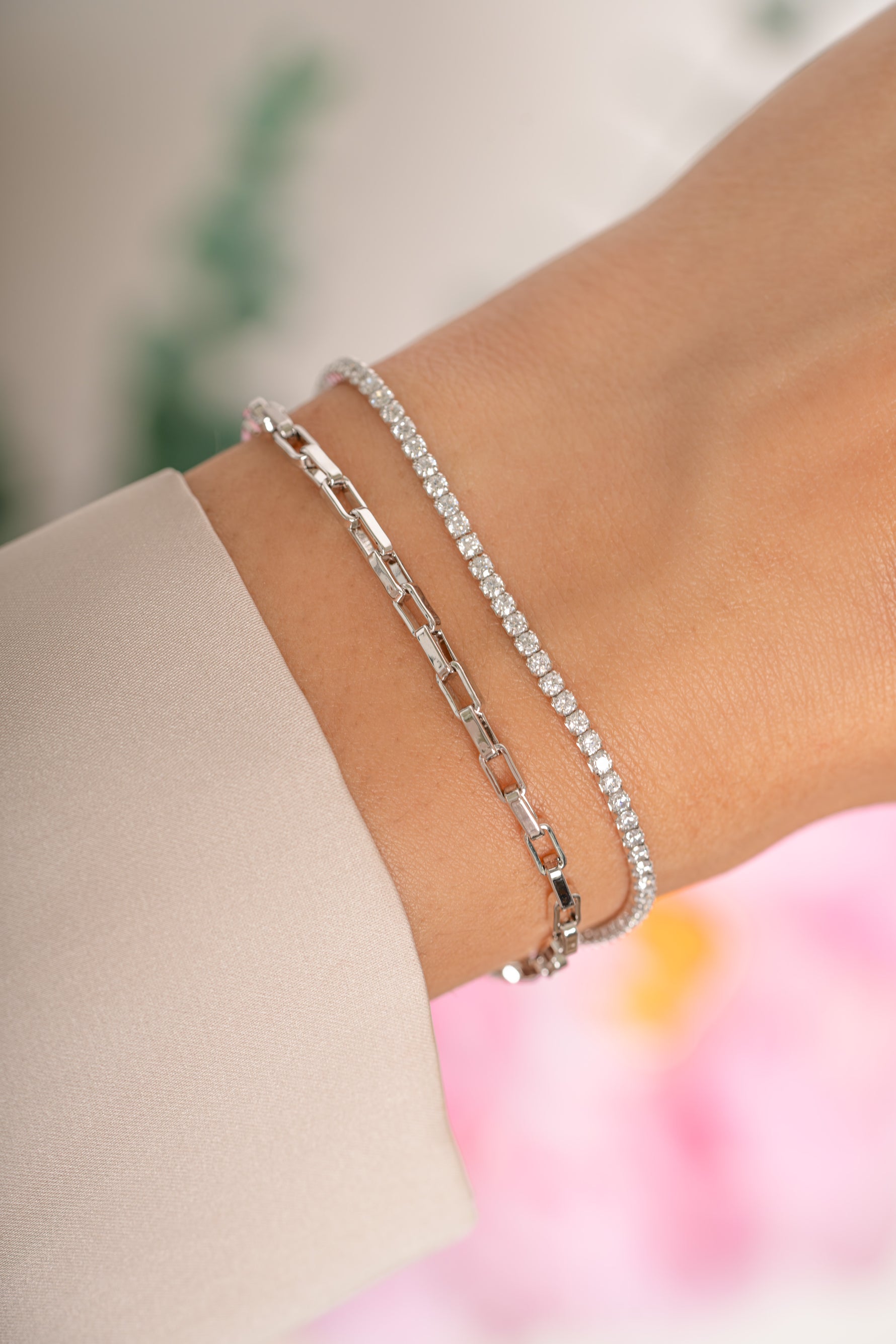 Sterling silver tennis and paperclip bracelet set from Sami Jewels displayed on a model. Elegant and stylish jewelry accessories.