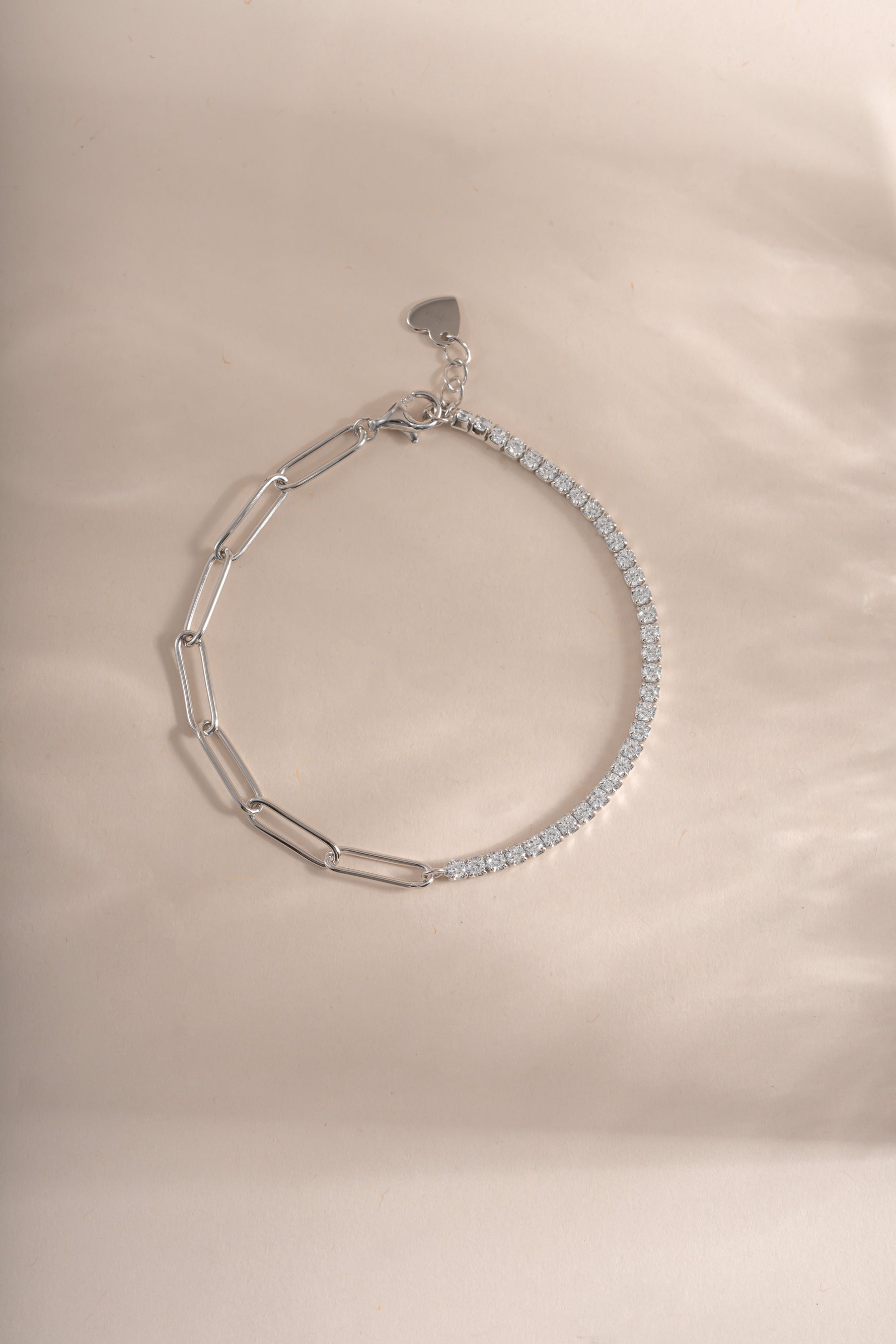 Sterling silver tennis and paperclip bracelet by Sami Jewels displayed flat with detailed chain links and clasp.