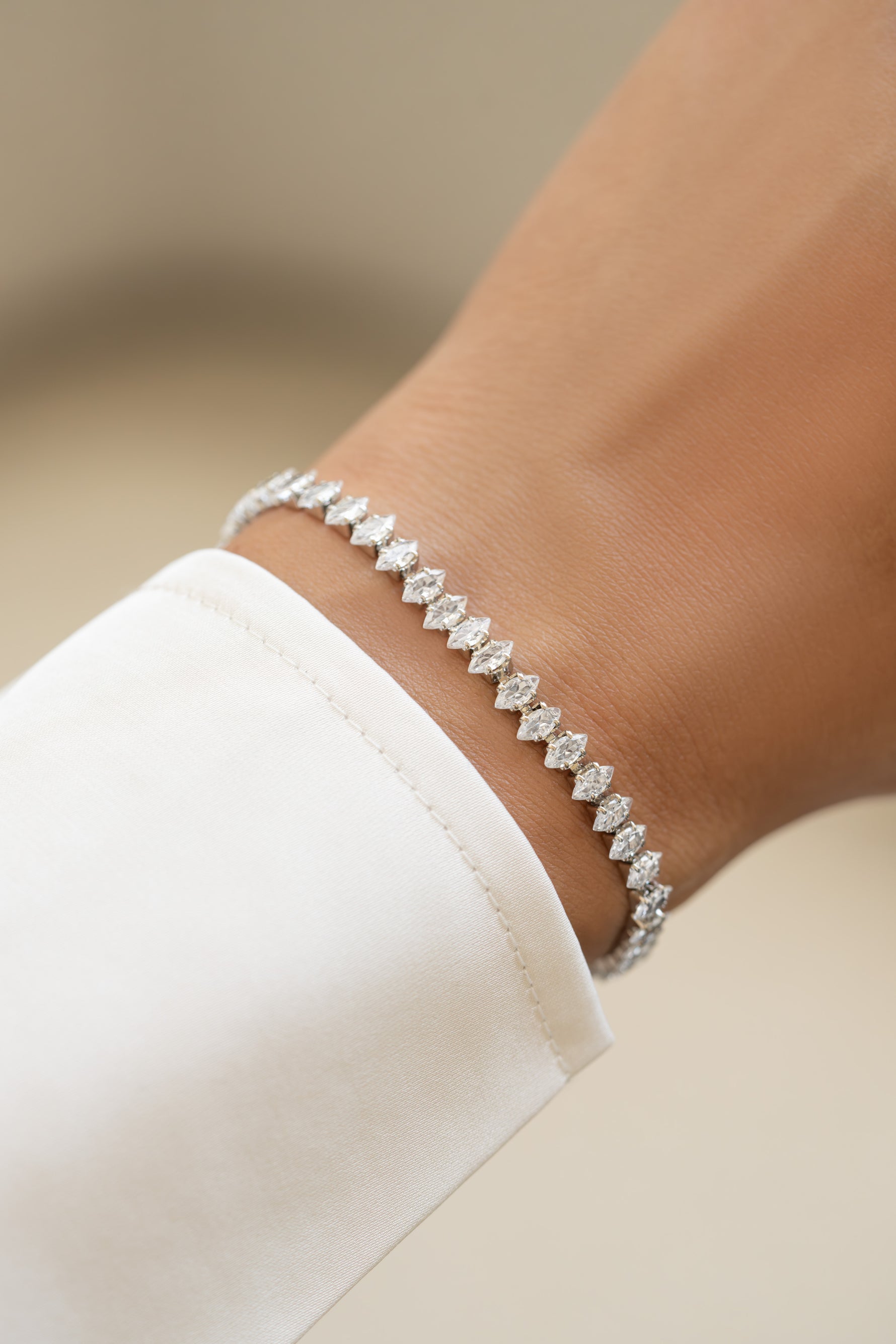 Gold Sami Jewels Marquise Tennis Bracelet with sparkling marquise stones, worn on a model's wrist.