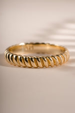 Close-up of a gold textured stacking ring from Sami Jewels, showcasing its detailed surface and elegant design.