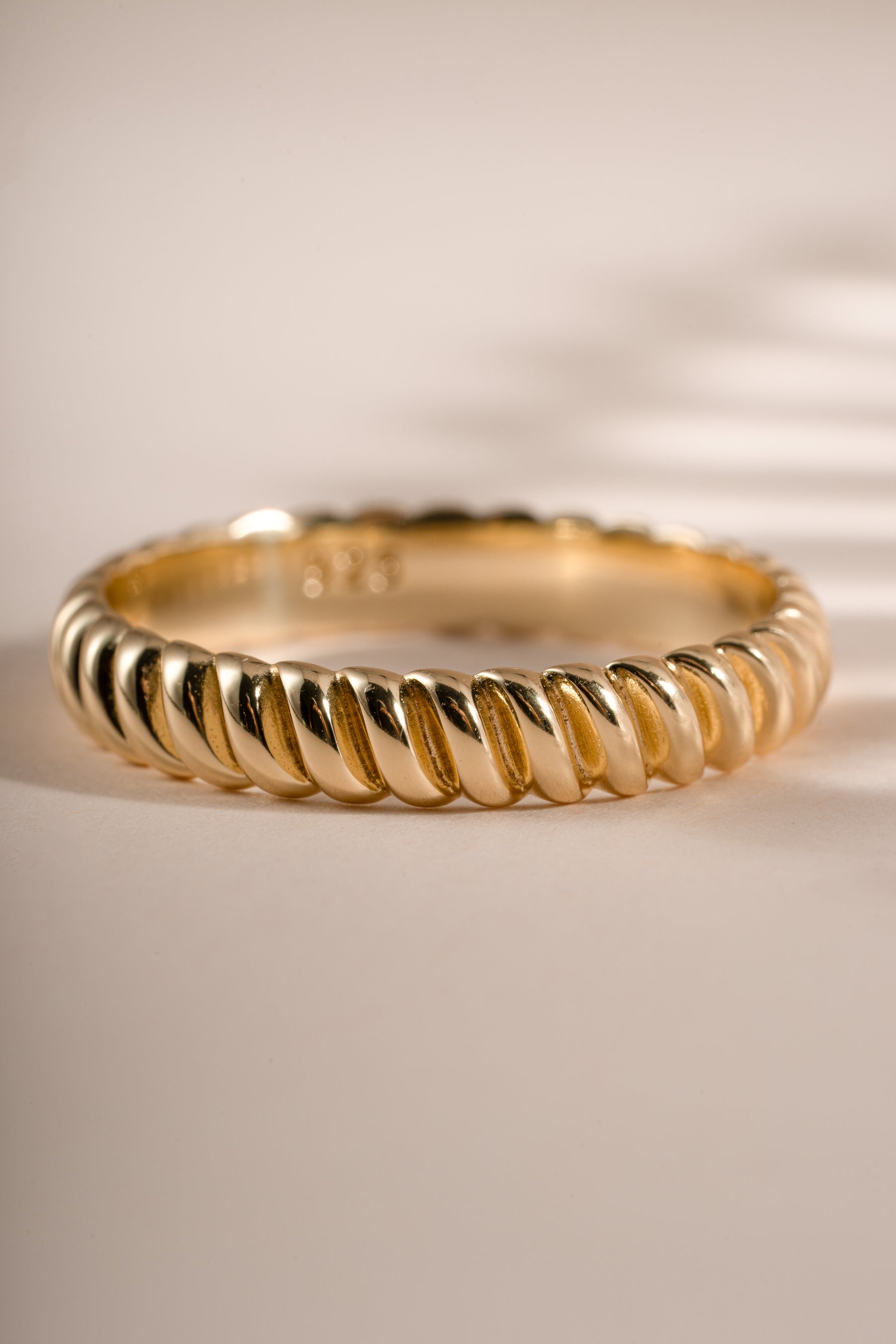 Close-up of a gold textured stacking ring from Sami Jewels, showcasing its detailed surface and elegant design.