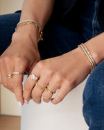 Gold textured stacking ring from Sami Jewels, showcasing a detailed, layered design on a model's finger.