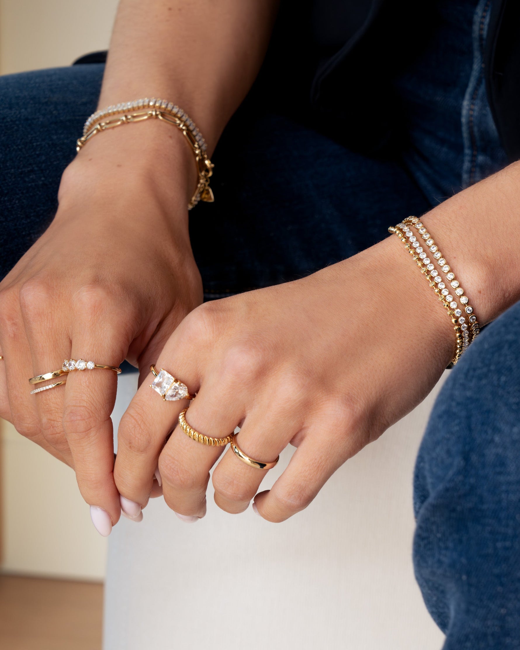 Gold textured stacking ring from Sami Jewels, showcasing a detailed, layered design on a model's finger.