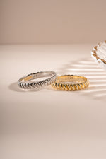 Close-up of Sami Jewels textured stacking ring in gold and sterling silver, showcasing its detailed design and finish.