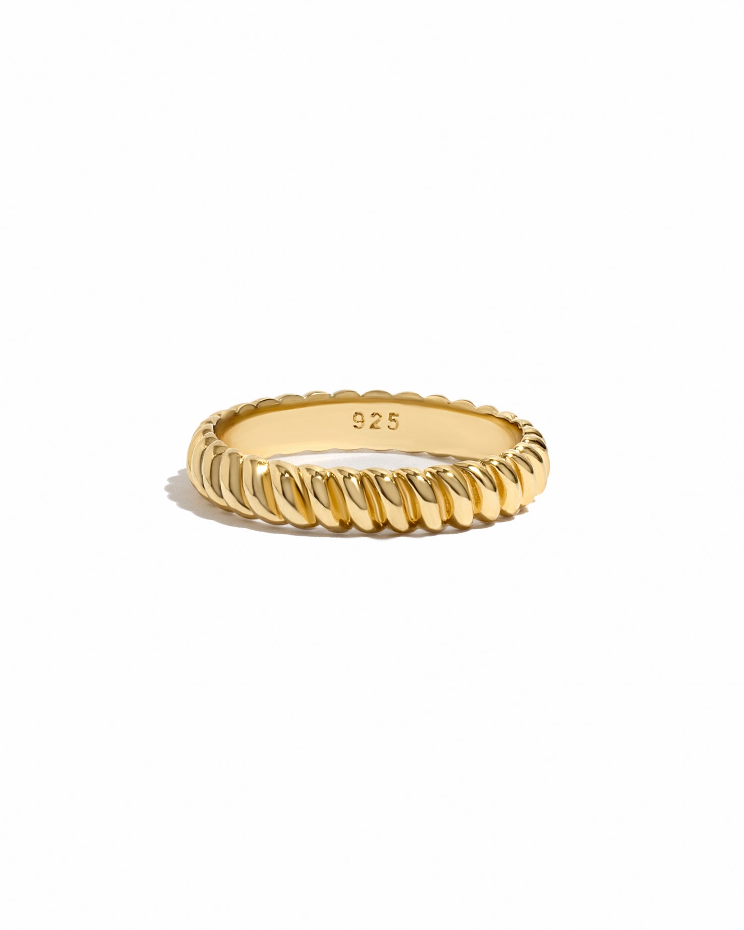 Gold textured stacking ring by Sami Jewels on a white background, showcasing its intricate design and shiny finish.