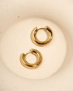 Close-up of gold stainless steel SS hoops earrings by Sami Jewels, showcasing thick huggie-style design and waterproof finish.