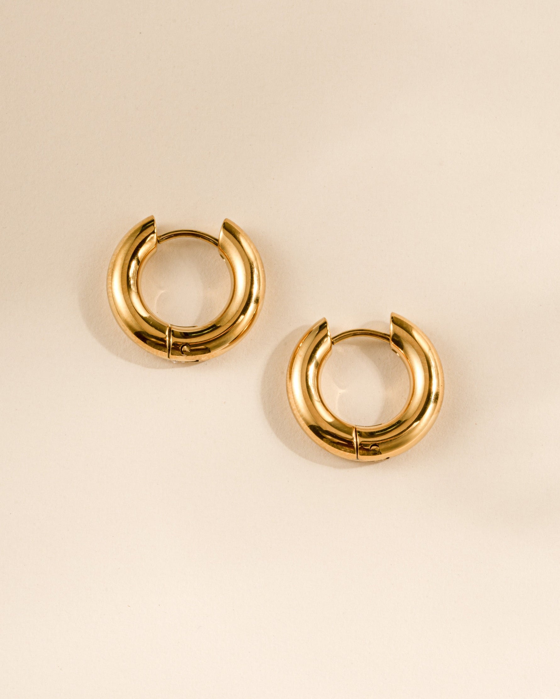 Gold stainless steel SS hoops earrings by Sami Jewels, thick huggie design with a waterproof finish.