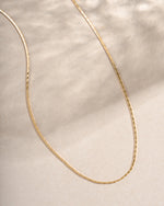 Gold thin chain necklace from Sami Jewels, close-up view showcasing delicate and sleek jewelry design.