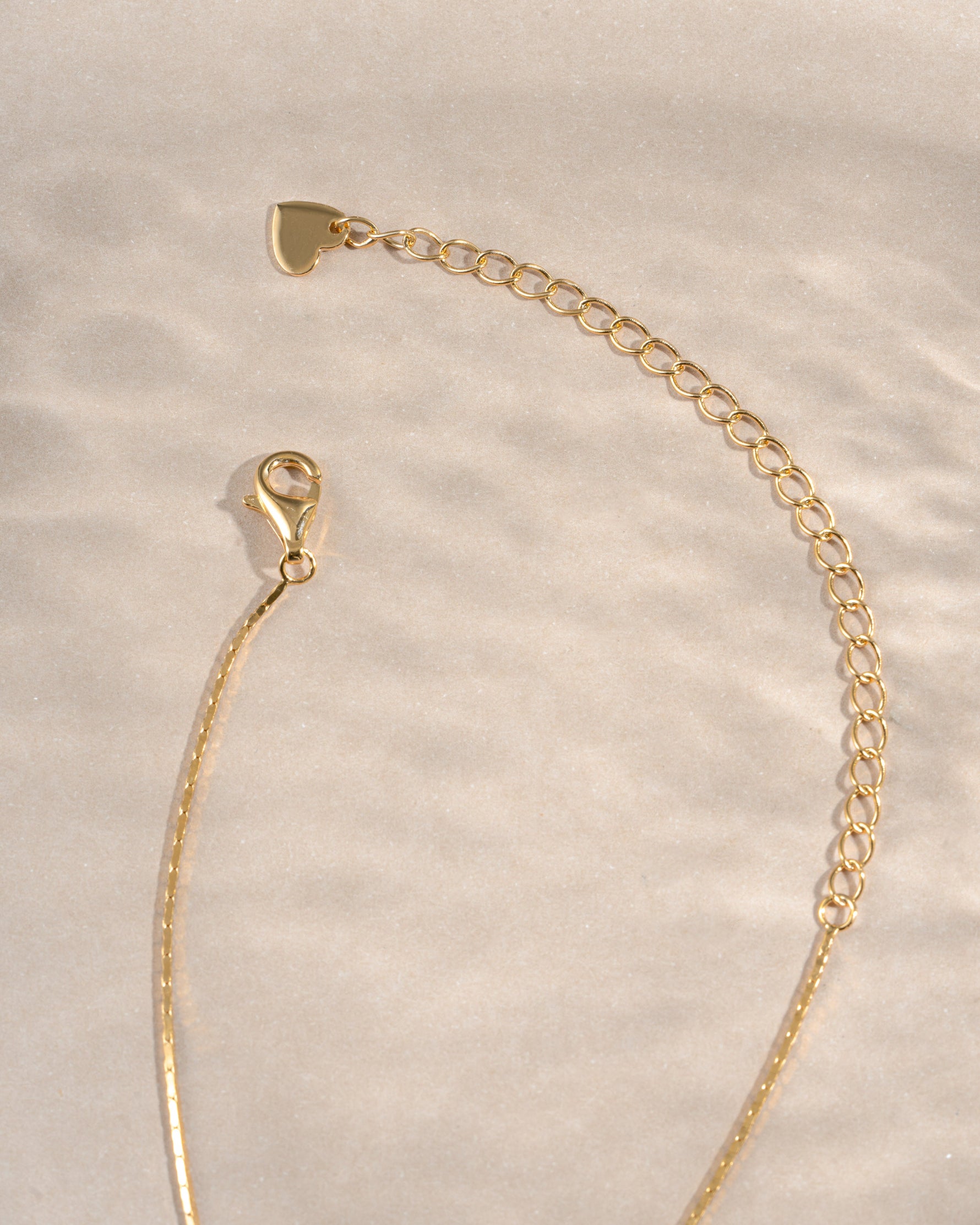 Gold thin chain necklace from Sami Jewels with a lobster clasp, showcasing a delicate and elegant jewelry piece.