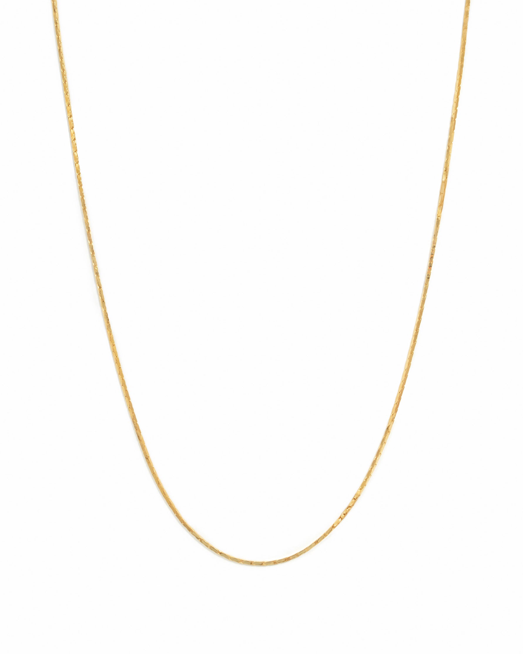 Gold thin chain necklace from Sami Jewels on a white background, showcasing its delicate and elegant design.