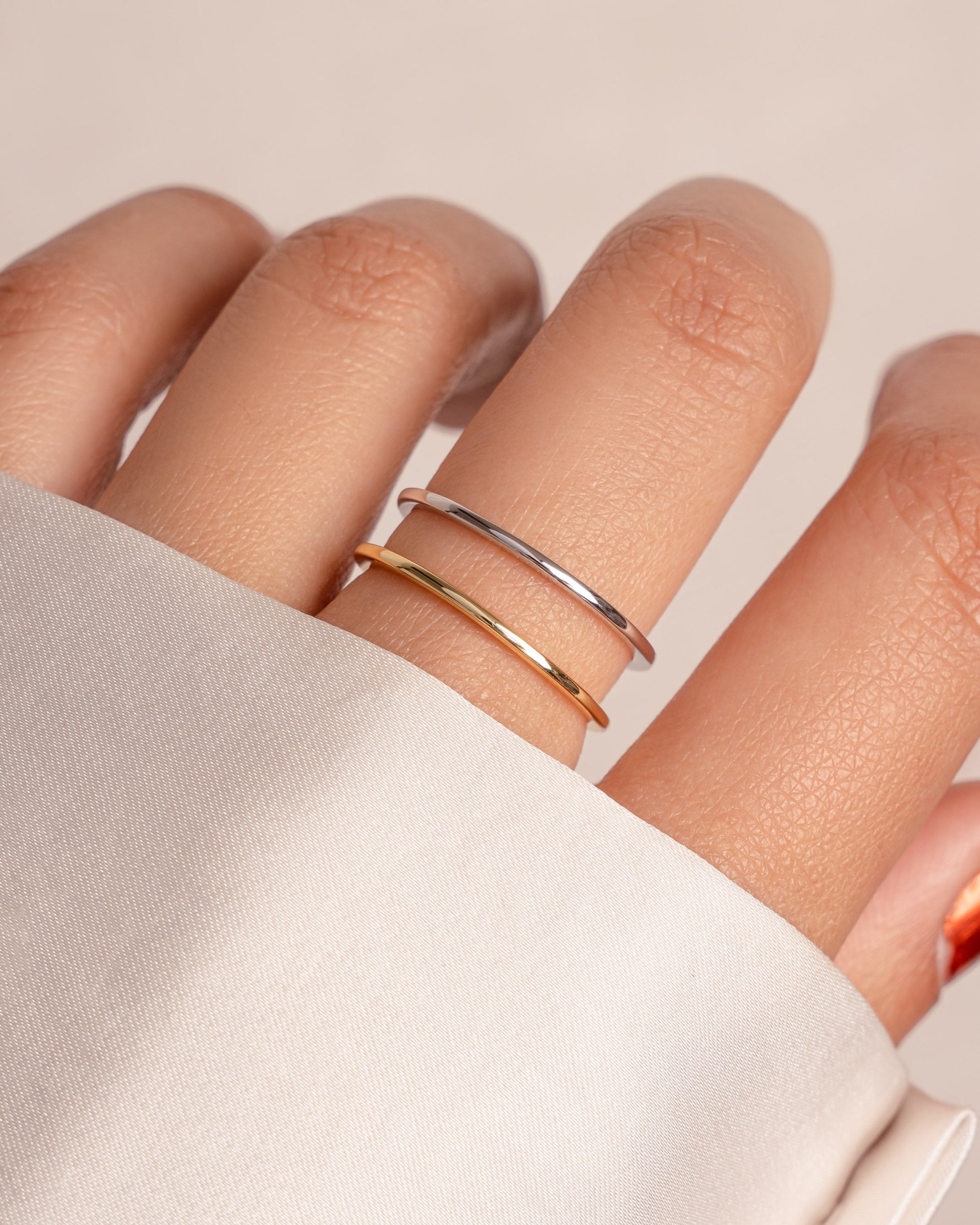 Thin plain band ring by Sami Jewels, featuring a sleek gold and sterling silver design, showcased on a neutral background.