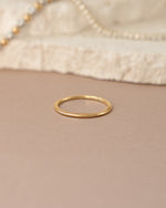 Gold thin plain band ring from Sami Jewels, showcasing a sleek, minimalist design in a front view.