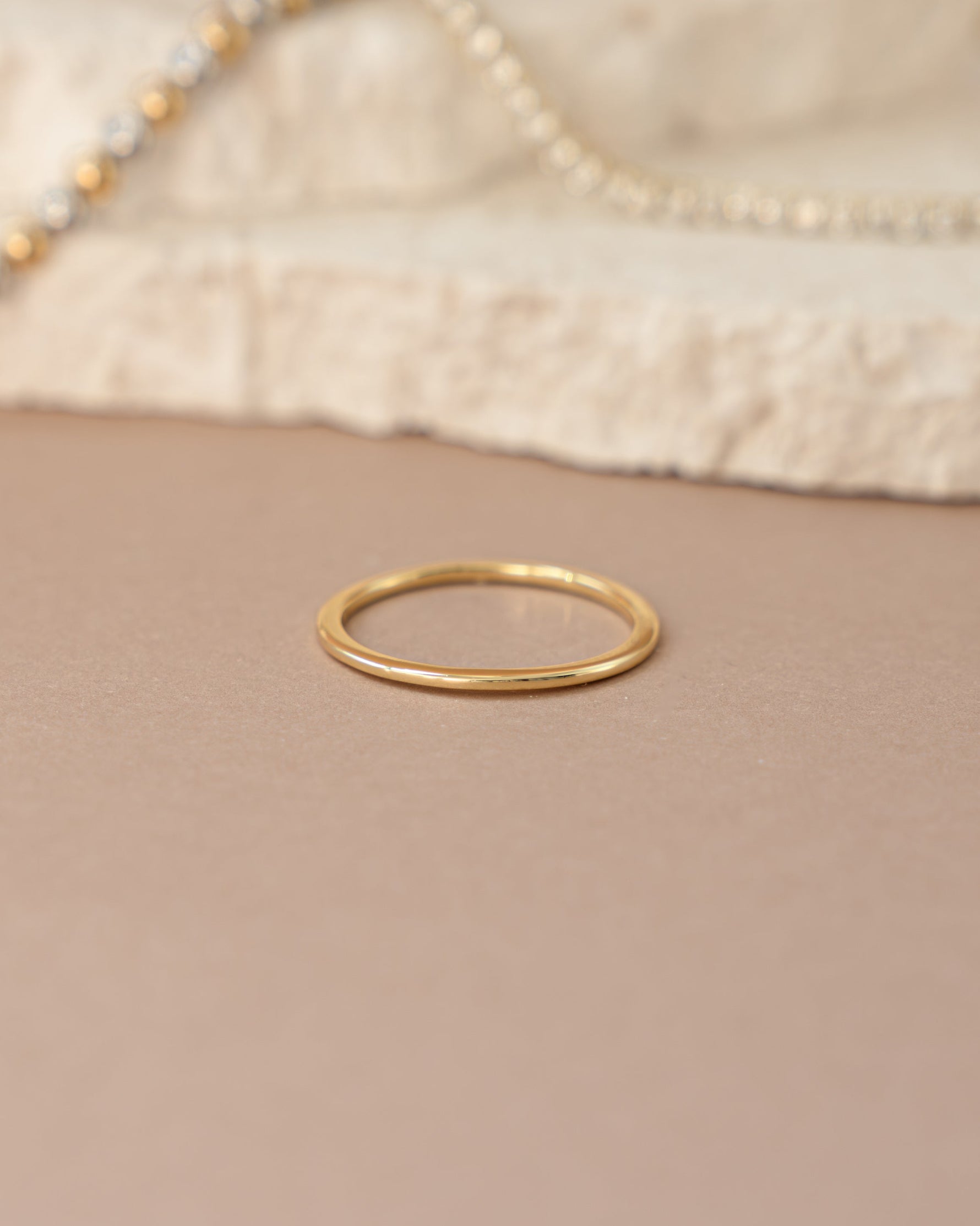 Gold thin plain band ring from Sami Jewels, showcasing a sleek, minimalist design in a front view.