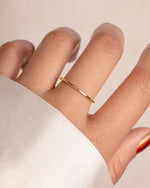 Gold thin plain band ring from Sami Jewels, close-up of sleek, minimalist design on a model's finger