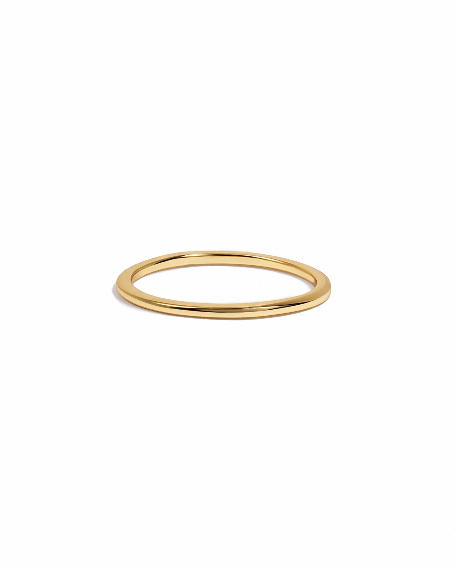 Gold thin plain band ring from Sami Jewels, close-up of simple, elegant jewelry on a white background.