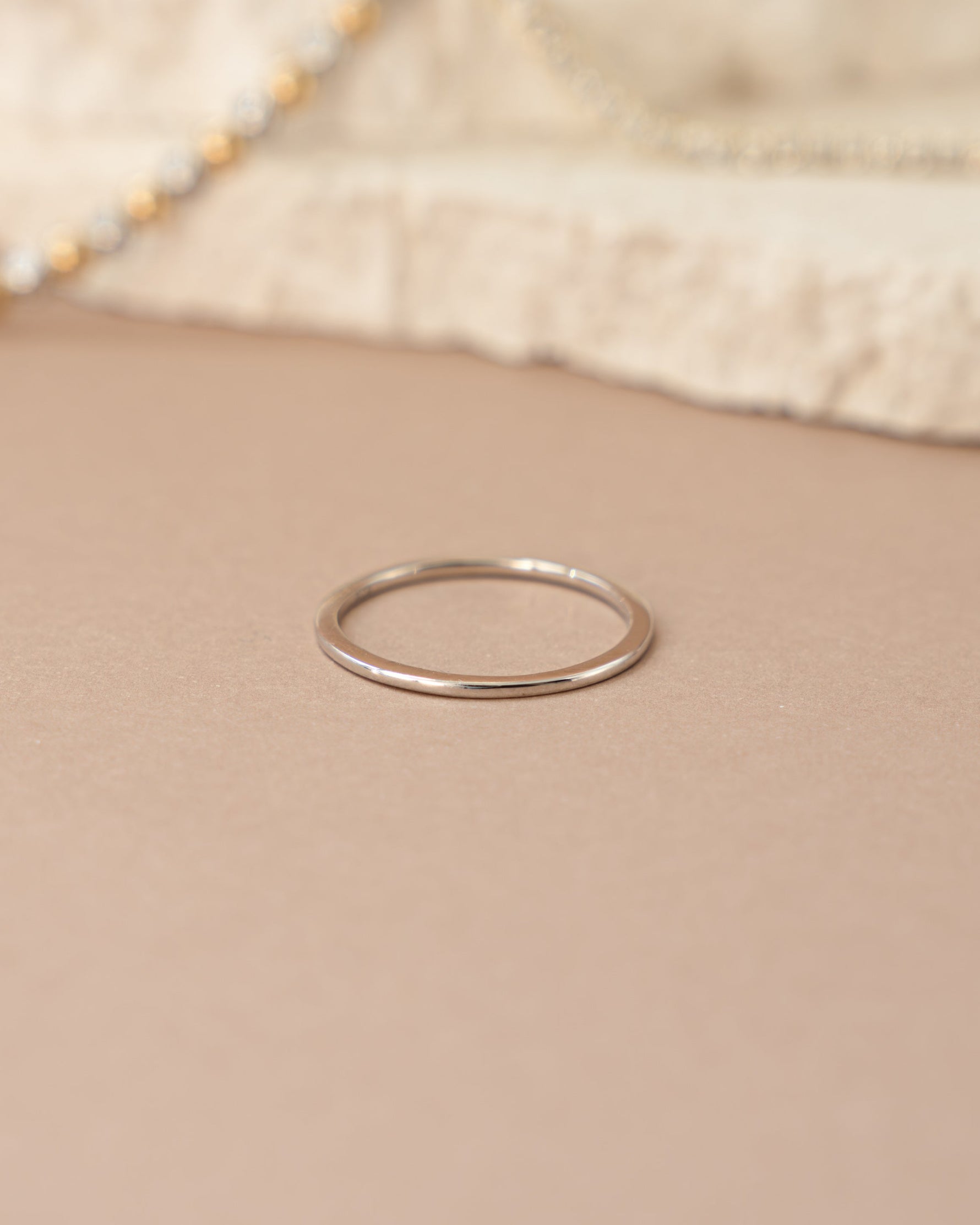 Sterling silver thin plain band ring by Sami Jewels, front view showing smooth, minimalist design.