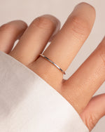 Sterling silver thin plain band ring by Sami Jewels, showcasing a sleek, minimalist design on a neutral background.
