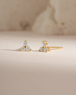 Gold three-stone CZ stud earrings by Sami Jewels, front view showing sparkling cubic zirconia stones in a classic stud design.