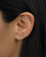 Gold three-stone CZ stud earrings by Sami Jewels, featuring sparkling cubic zirconia stones set in a classic design.