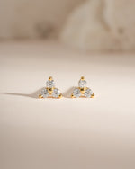 Sami Jewels three stone CZ stud earrings featuring sparkling cubic zirconia stones set in gold.
