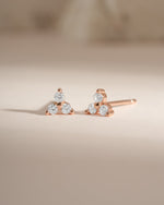 Rose gold three-stone CZ stud earrings by Sami Jewels, featuring sparkling cubic zirconia gemstones in a classic setting.