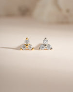 Sterling silver and gold three-stone CZ stud earrings by Sami Jewels, showcasing sparkling cubic zirconia stones.