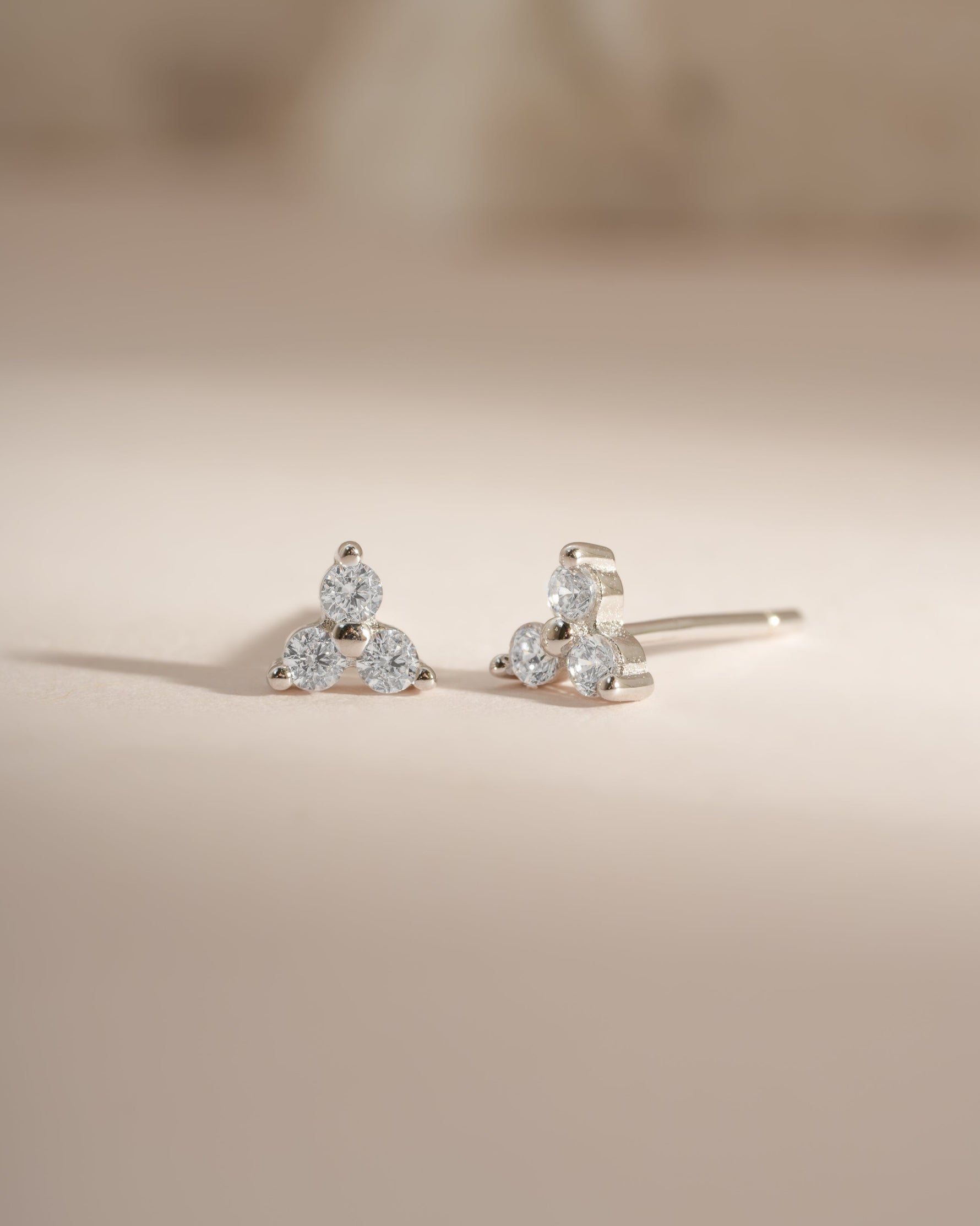Sterling silver three-stone CZ stud earrings by Sami Jewels featuring sparkling cubic zirconia stones.