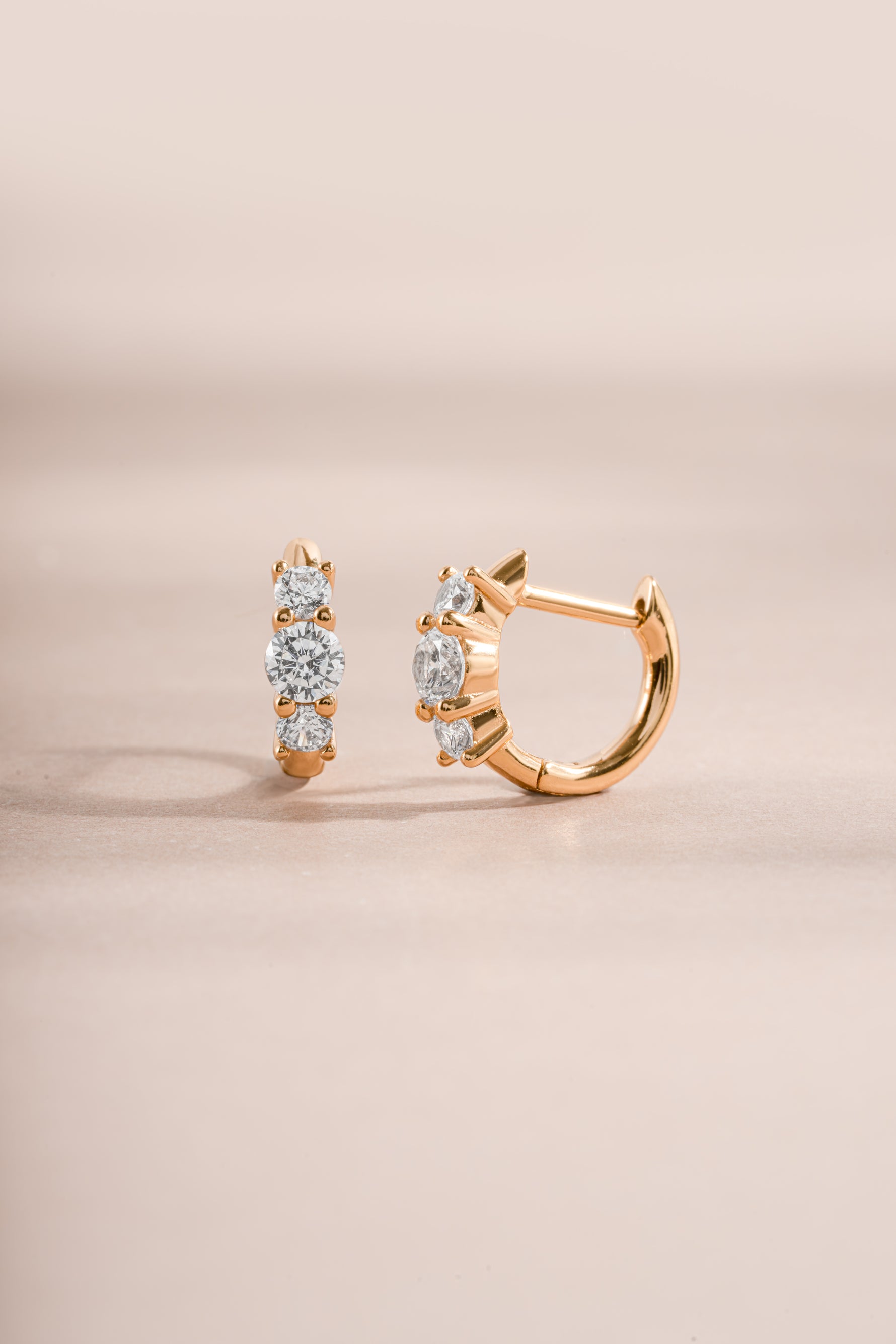 gold three stone huggie earring side view