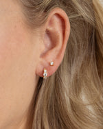 gold three stone huggie earring on model