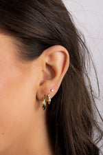 gold three stone huggie earring stack on model