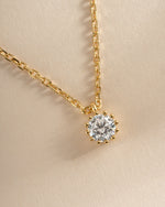 Close-up of Sami Jewels Tiny Bezel Pendant Necklace in gold, showcasing the delicate bezel setting and fine chain.