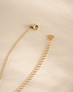 Gold Tiny Bezel Pendant Necklace with lobster clasp by Sami Jewels, close-up view of delicate jewelry on a white background.